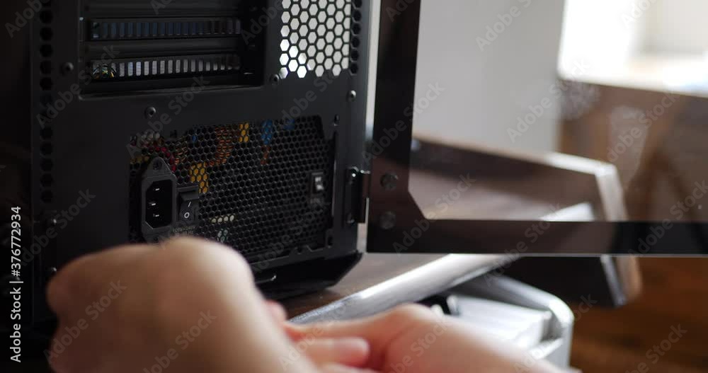 A computer repair technician assembling a new gaming pc case with a screw driver tool.