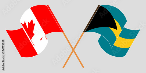 Crossed and waving flags of Bahamas and Canada