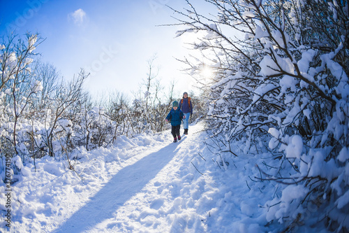 Woman with a child on a winter hike in the mountains.