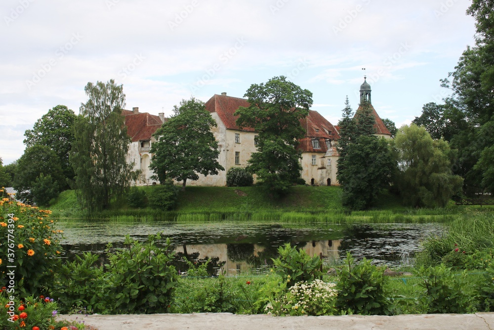 The old beautiful Jaunpils castle is landmark in the territory of Latvia on summer day 2020