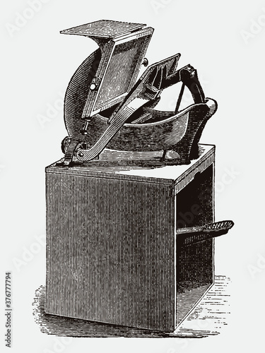 Antique foot treadle printing press on wood stand, in three-quarter front view after an engraving from the 19th century