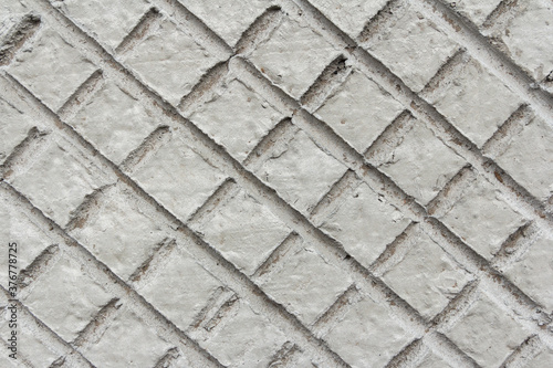 Concrete texture with squeezed shapes in the form of a diamond. Industrial background