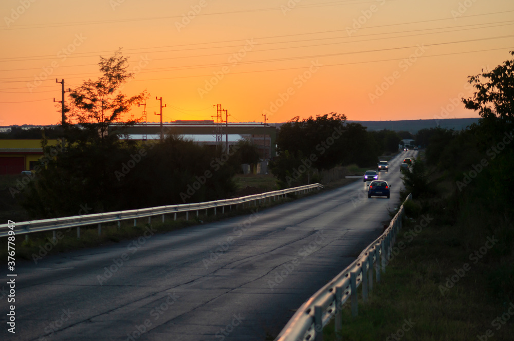 Road with cars at sunset