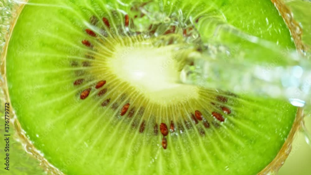 Super Slow Motion Shot of Splashing Water on Rotating Kiwi Slice at 1000fps. Super Slow Motion Shot of Splashing Water on Rotating Kiwi Slice at 1000fps.