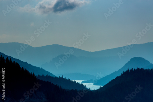 View of Rimrock Lake flowing amidst mountain range photo