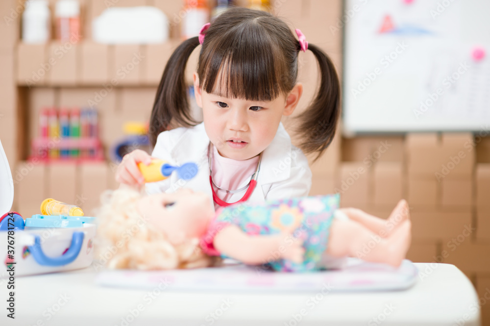 Fototapeta premium young girl pretend play doctor role at home