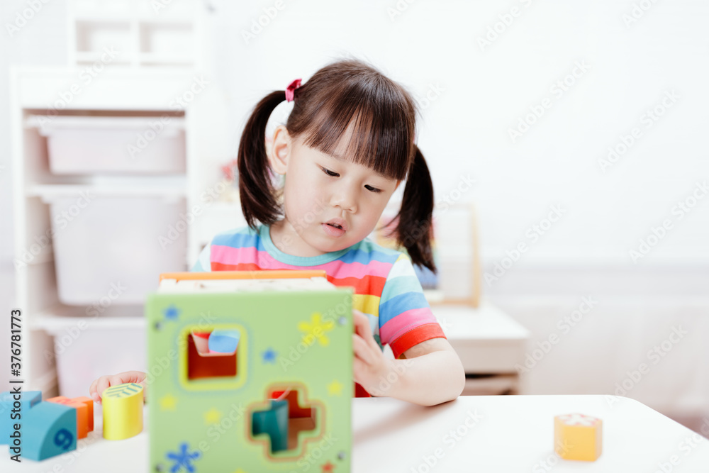 young girl playing number shape blocks for homeschooling young girl playing number shape blocks for homeschooling