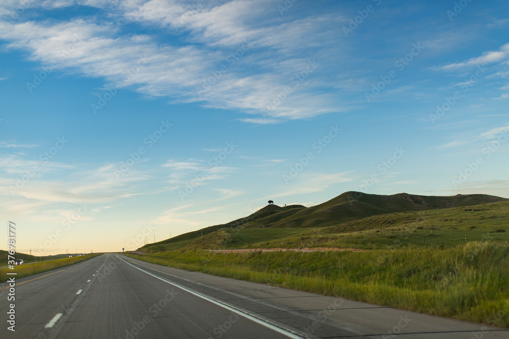 Empty road passing through fields