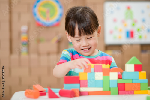  young girl playing creative toy blocks for homeschooling