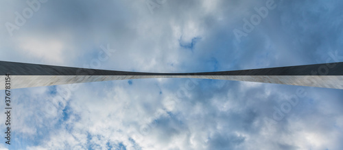 Low angle view of Gateway Arch against cloudy sky