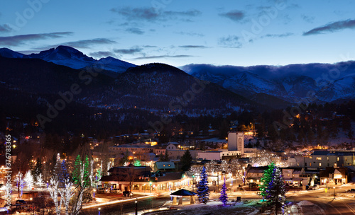 View of illuminated Estes Park town with Longs Peak mountains in background photo