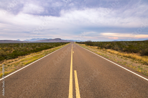 Road passing through desert landscape