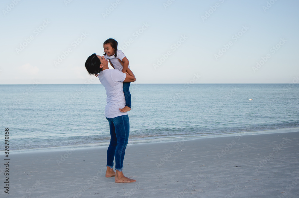 Mom and daughter on the beach running around and having fun
Mom and daughter on the beach running around and having fun