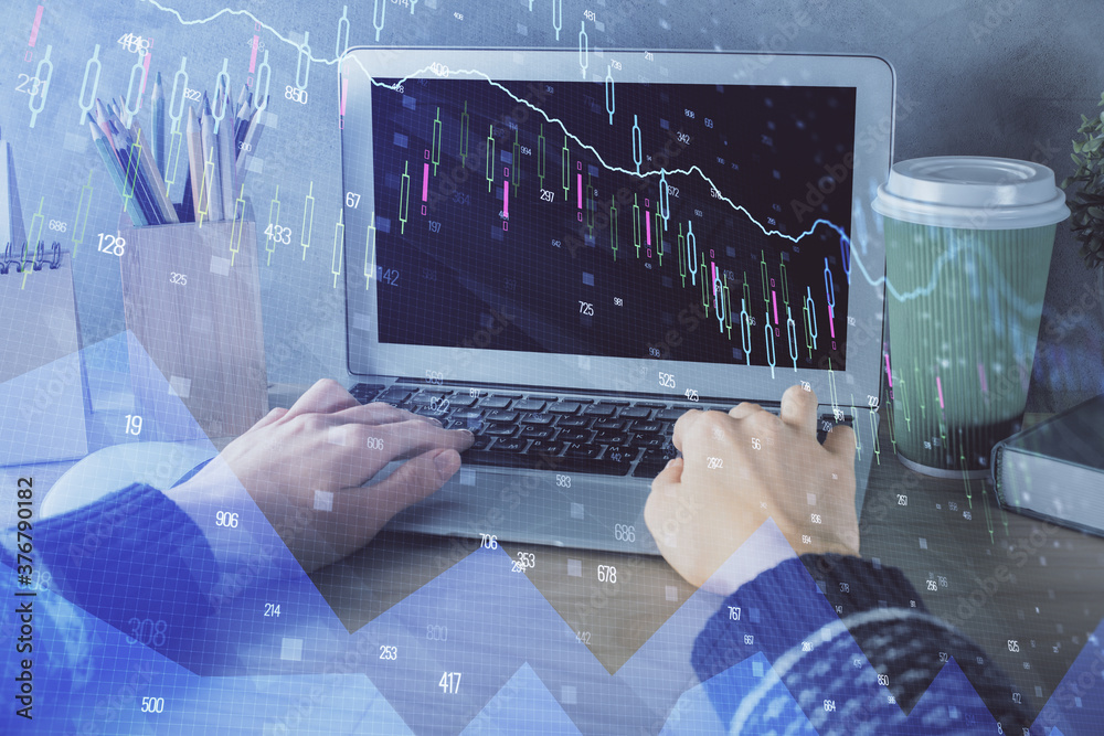 Double exposure of woman hands typing on computer and forex chart hologram drawing. Stock market invest concept.