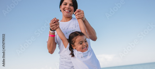 Mom and daughter on the beach running around and having fun stock photo royalty free 