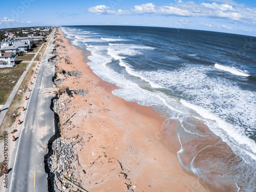 Aerial view of beach by broken coastal road photo