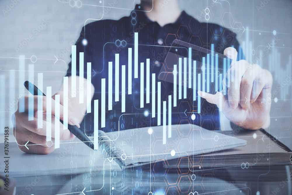 Double exposure of man hands holding a credit card and Forex graph drawing. Stock trading and digital fintech in Internet E-commerce concept. Double exposure of man hands holding a credit card and Forex graph drawing. Stock trading and digital fintech in Internet E-commerce concept.