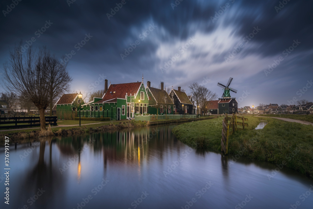 View of Zaanse Schans village against cloudy sky during sunrise View of Zaanse Schans village against cloudy sky during sunrise