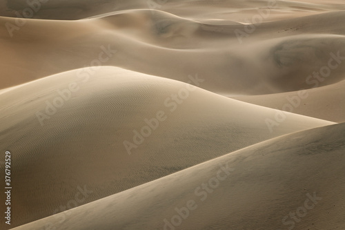 View of sand dunes during sunset photo