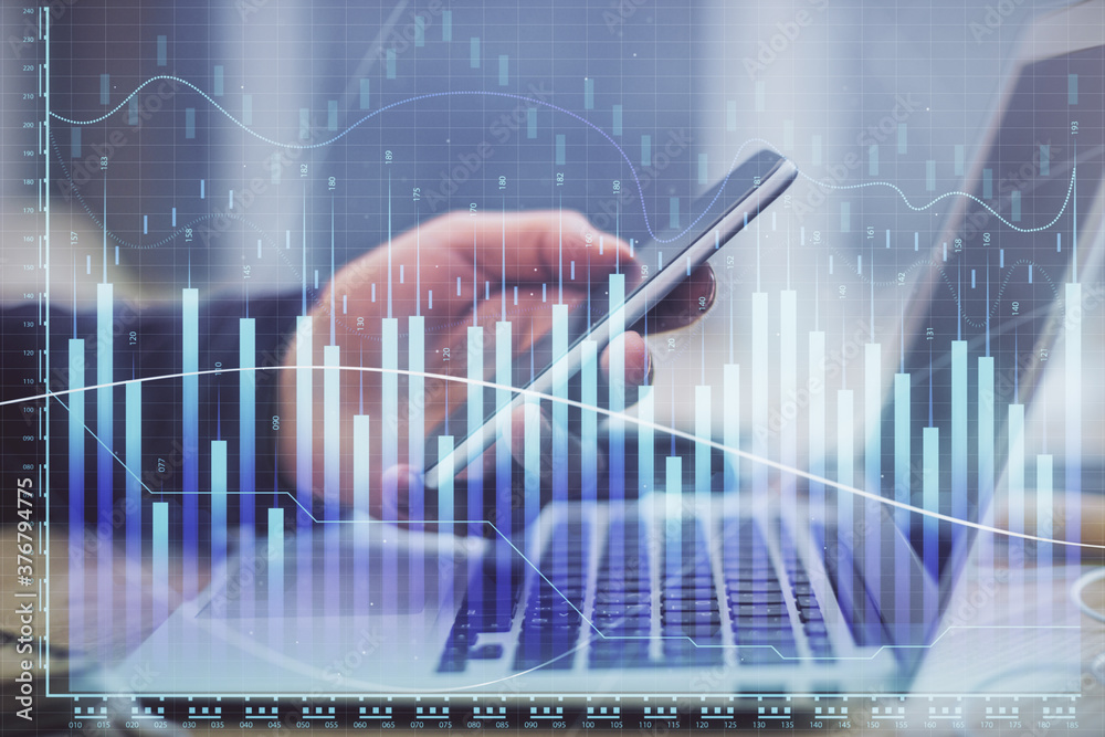 Double exposure of man's hands holding and using a phone and financial graph drawing. Analysis concept. Double exposure of man's hands holding and using a phone and financial graph drawing. Analysis concept.