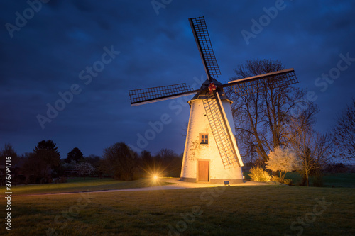 View of windmill against sky at dusk photo