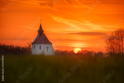 View of chapel against cloudy sky during sunset