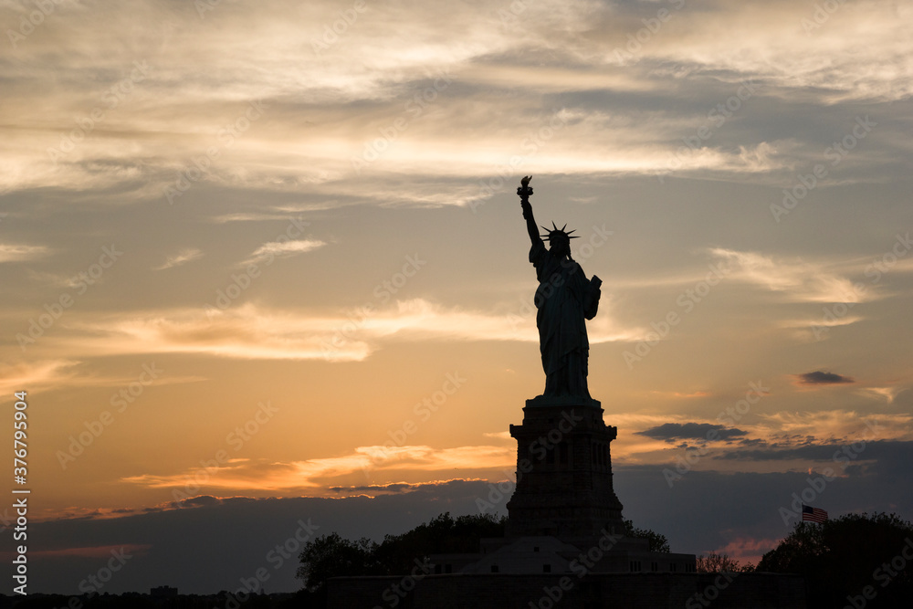 View of Statue of Liberty against cloudy sky during sunset View of Statue of Liberty against cloudy sky during sunset