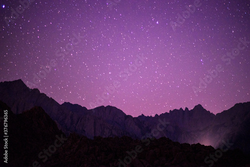 Scenic view of stars illuminated over mountains at night photo