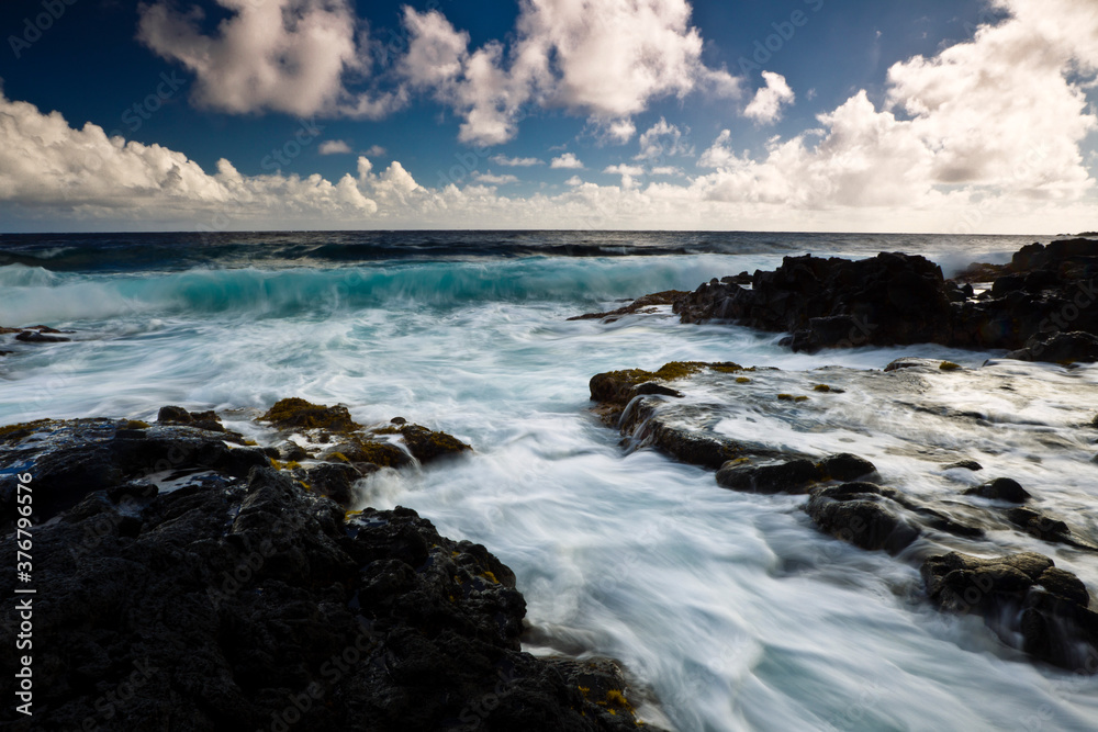 Scenic view of Pacific ocean waves splashing on rocky coastline Scenic view of Pacific ocean waves splashing on rocky coastline