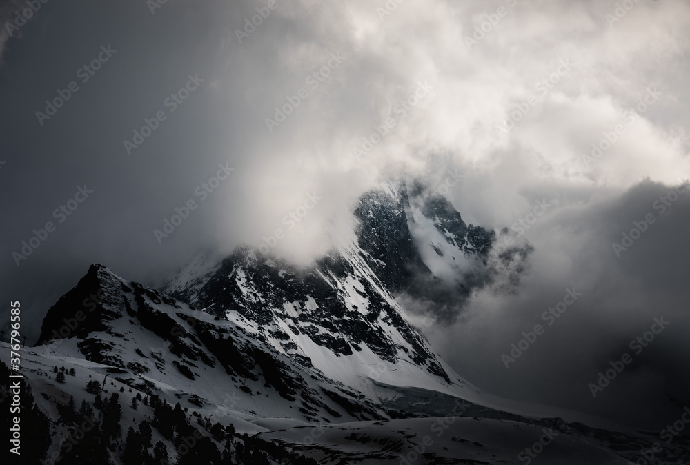 Scenic view of Matterhorn Mountain covered with snow against cloudy sky