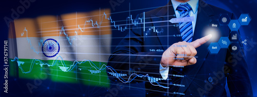 Businessman touching data analytics process system with KPI financial charts, dashboard of stock and marketing on virtual interface. With India flag in background.