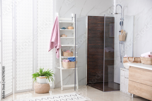 Bathroom interior with shower stall and shelving unit. Idea for design
