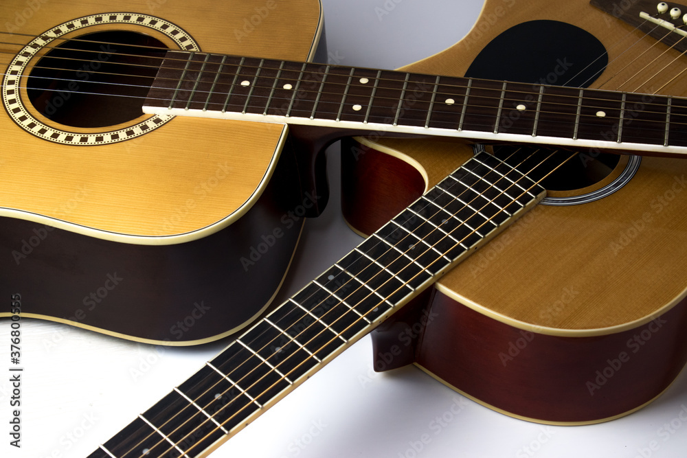 Two guitars lie crosswise on top of each other. Musical instrument.