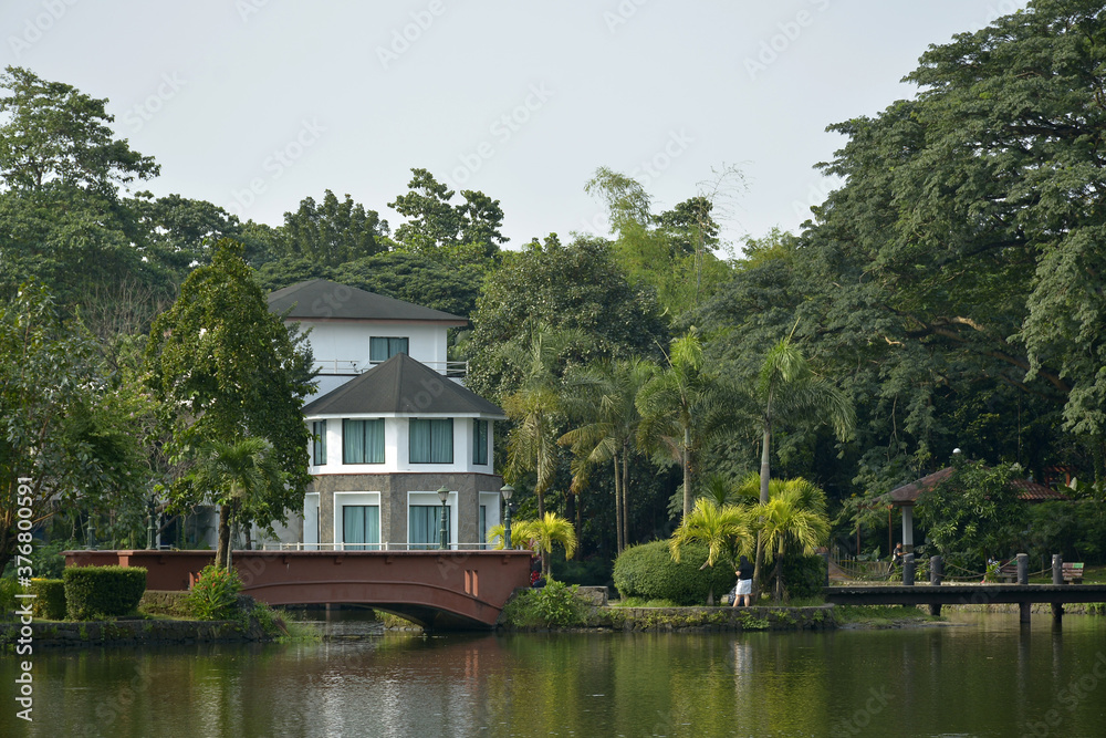 Ninoy Aquino parks and wildlife water lagoon plus house facade in Quezon City, Philippines