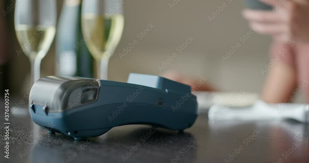 Woman pay on cellphone with pos machine
