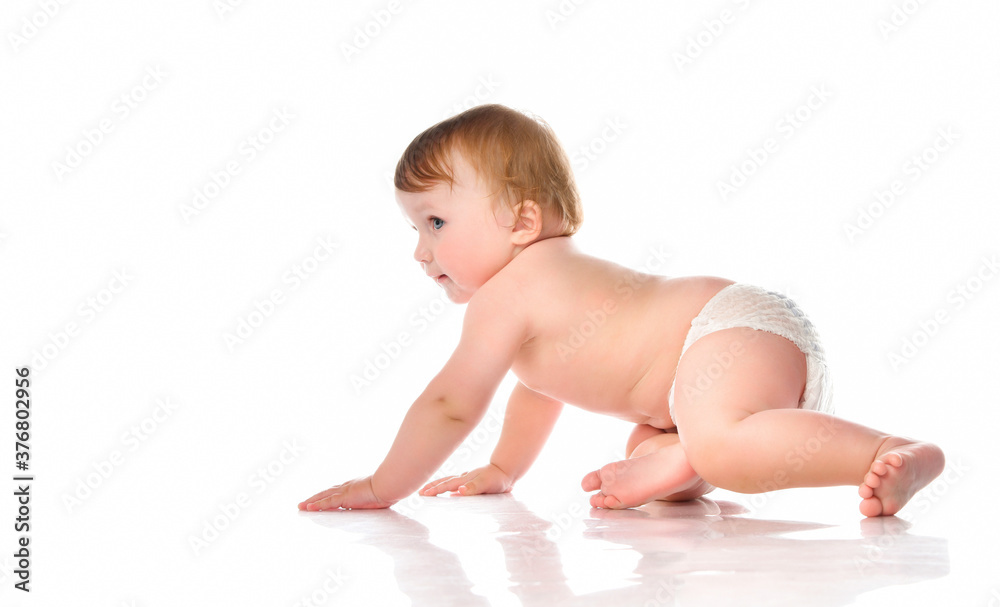 Creeping little boy in diapers in the studio on a white background. Creeping little boy in diapers in the studio on a white background.