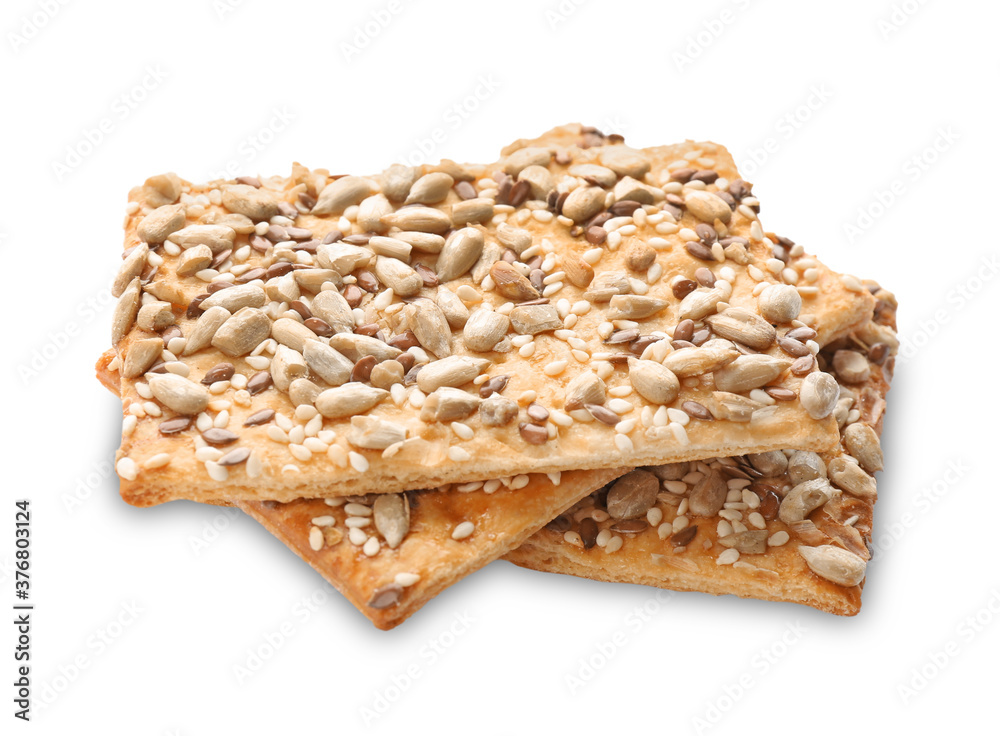 Delicious crispy crackers with different seeds isolated on white Delicious crispy crackers with different seeds isolated on white