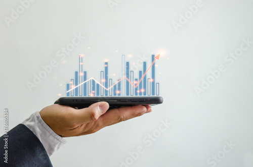 Business planning growth chart increases with Financial Chart on smartphone.Digital communications technology
