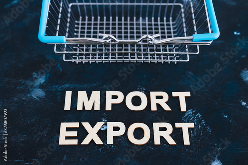 international trade concept, Import Export text next to shopping basket