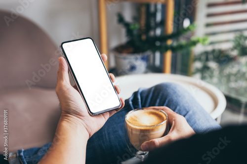 cell phone mockup blank white screen.man hand holding texting using mobile on desk at coffee shop.background empty space for advertise.work people contact marketing business,technology