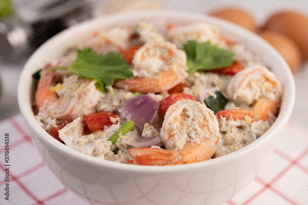 Shrimp Salad with Tomato Red onion and coriander in a white cup.