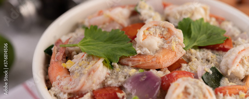 Shrimp Salad with Tomato Red onion and coriander in a white cup.