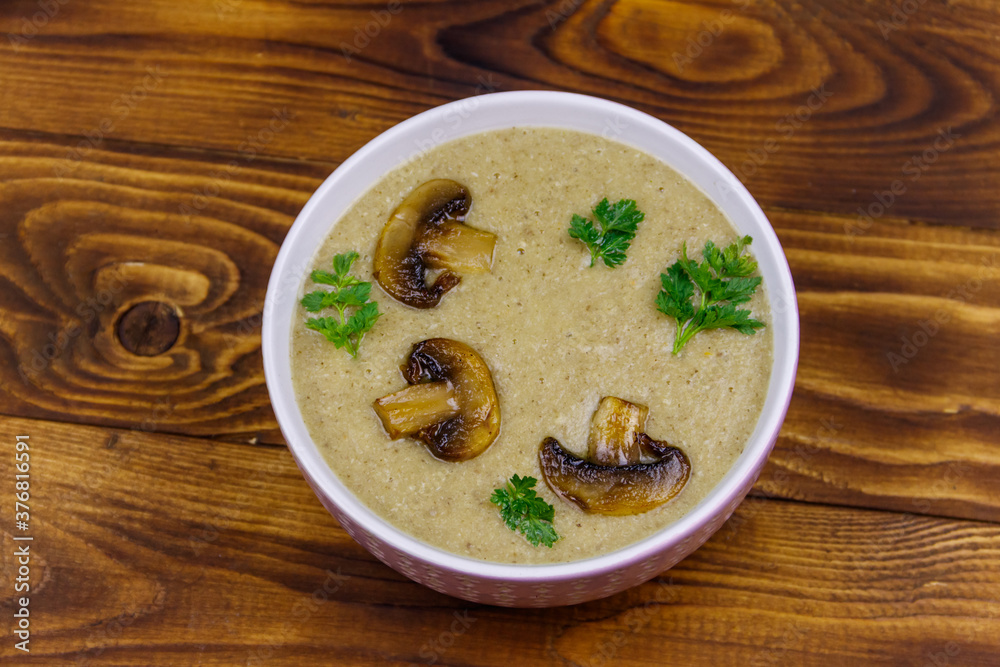 Mushroom cream soup on a wooden table. Top view Mushroom cream soup on a wooden table. Top view