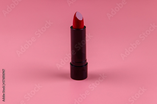 Red lipstick on a pastel pink background