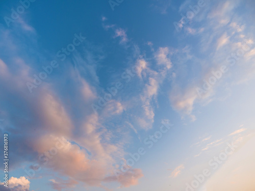 Whimsical clouds in the blue sky. Summer evening