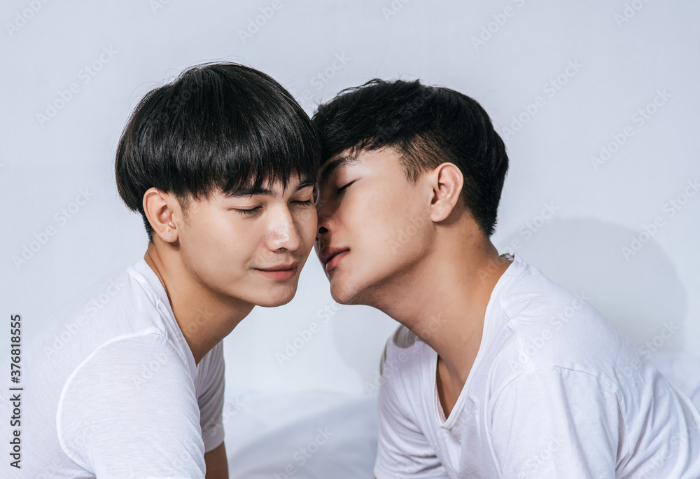 Two loving young men hugged and fragrant cheek each other. Two loving young men hugged and fragrant cheek each other.