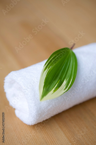 rolled towel topped with leaf