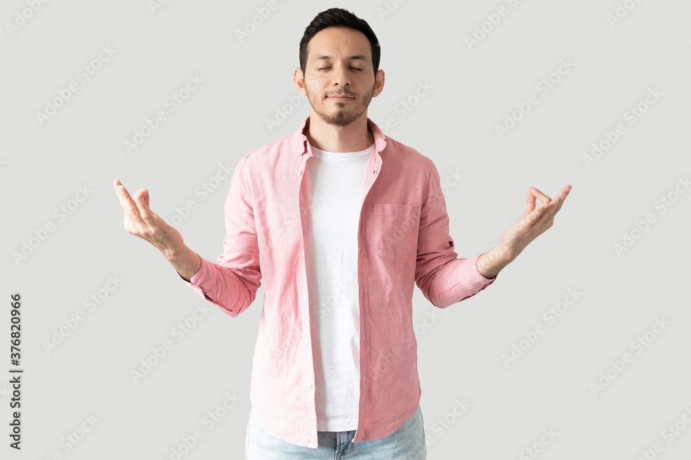 Man trying to meditate in a studio Man trying to meditate in a studio