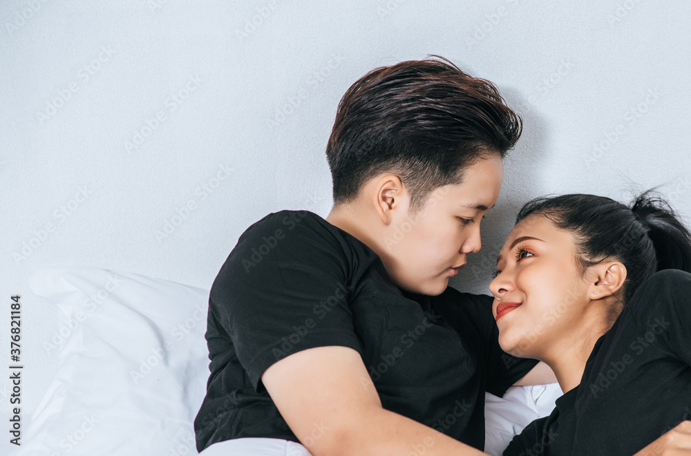 Two female couples cuddled together in bed. Two female couples cuddled together in bed.
