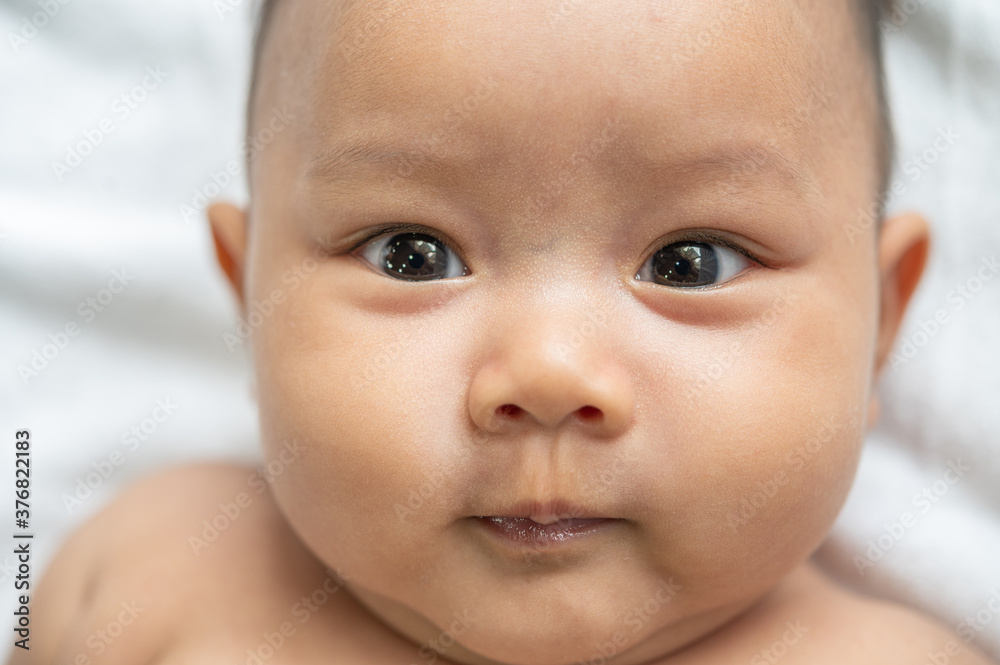 A newborn baby who opens his eyes and looks forward A newborn baby who opens his eyes and looks forward
